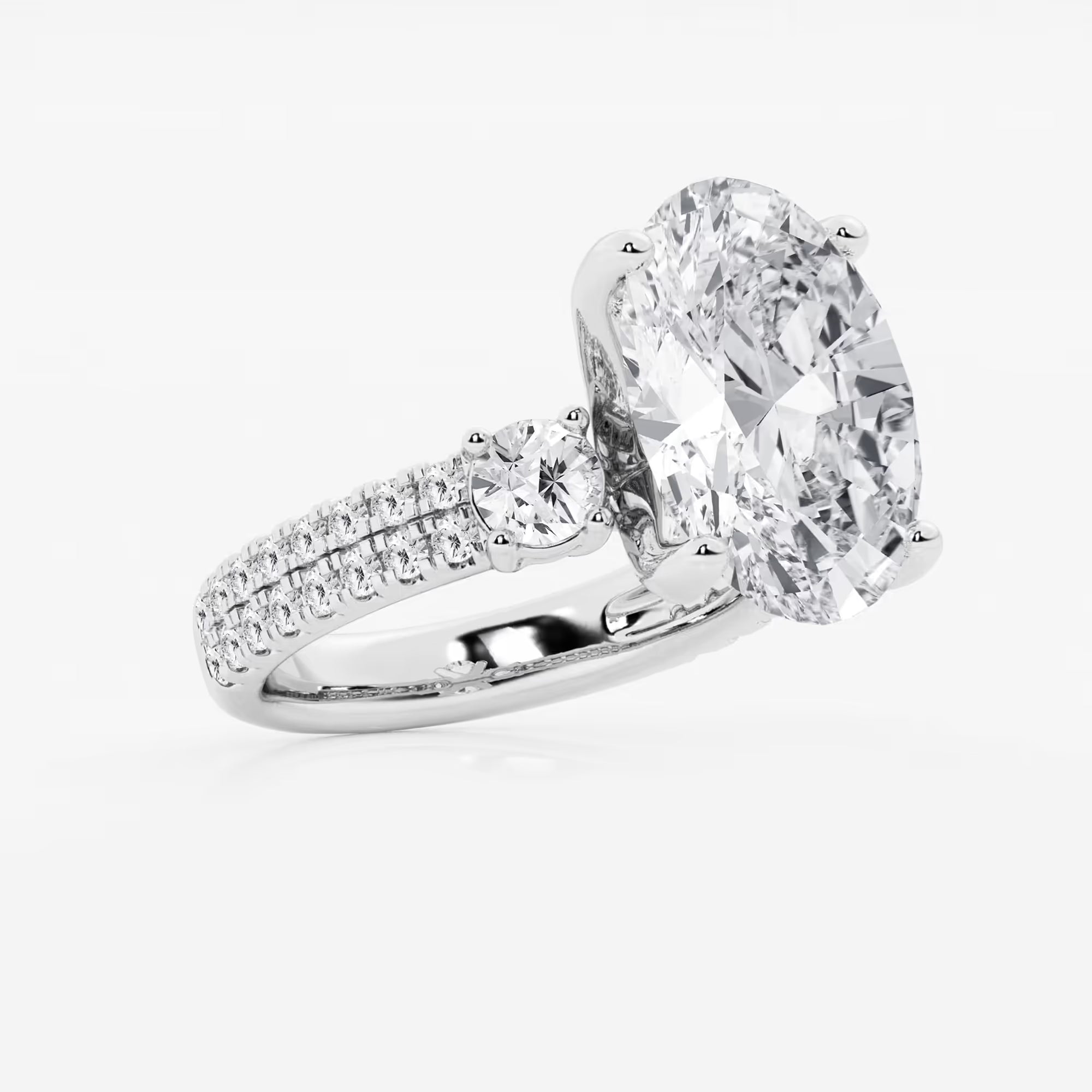 Luxurious Oval Cut Three-Stone Lab-Grown Diamond Pavé Engagement Ring